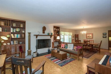 Large living and dining room with fireplace and bu