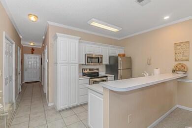 Kitchen with kitchen peninsula, white cabinets, li