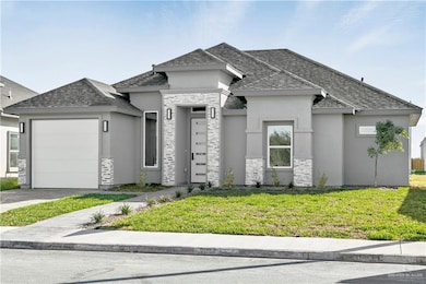View of front of home featuring a front yard and a garage