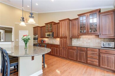 Gourmet kitchen with hardwood floors, granite coun