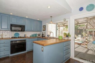 Quaint Kitchen with Custom Painted Cabinets and Co
