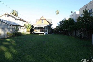 Large backyard with many fruit bearing trees and a
