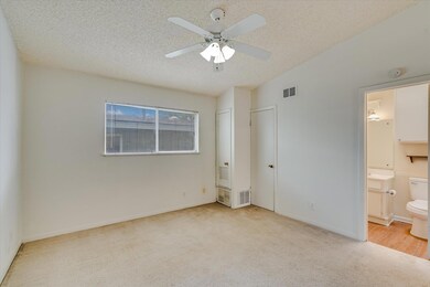Unfurnished bedroom with carpet, a textured ceili
