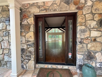 Property entrance featuring stone siding