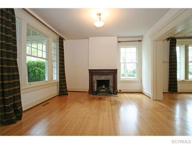 Living room with gas log fireplace is open to the dining room and the center hall.