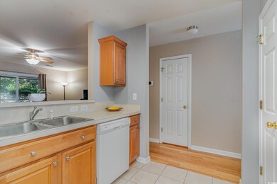 Kitchen featuring ceiling fan, white dishwasher, l
