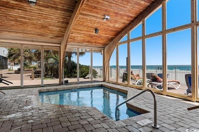 Indoor pool featuring a water view