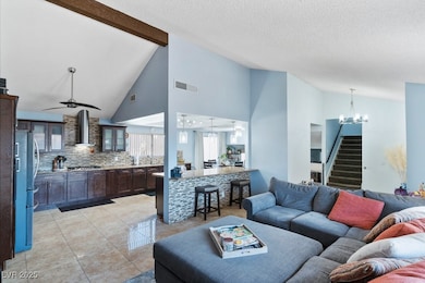 Living area featuring lofted ceiling with beams, v