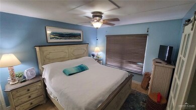Bedroom with a barn door and ceiling fan