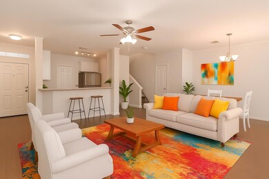 Living area with ceiling fan and crown molding
