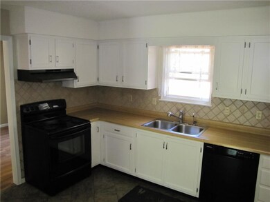 Kitchen opens up to living room and dining area
