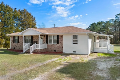 Ranch-style house featuring a porch, a front yard,