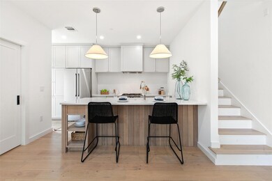 Kitchen with wall chimney range hood, tasteful ba