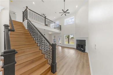Staircase with ceiling fan, wood finished floors,