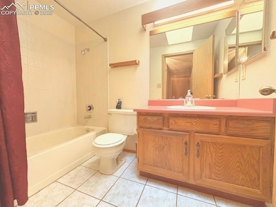 Full bathroom with vanity, light tile patterned floors, and shower / tub combo