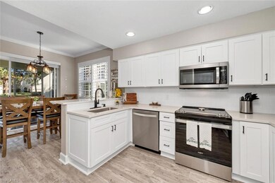 Kitchen with custom  cabinetry, stainless sink, an