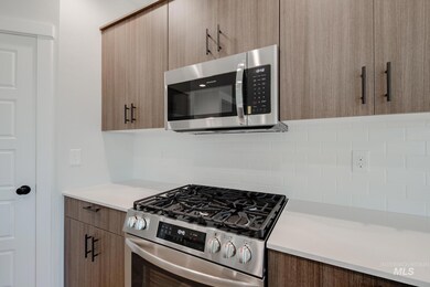 Kitchen featuring stainless steel appliances, modern cabinets, and decorative backsplash