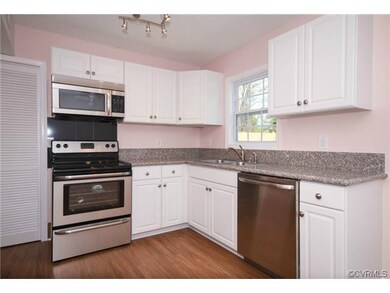 Another view of the kitchen with door to utility room.