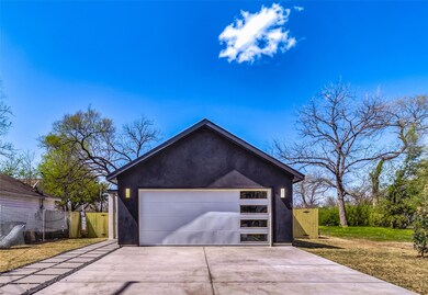 Garage with driveway and fence