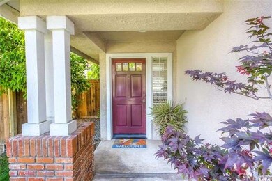 Charming front portico with brick accents and pill
