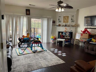 Living area featuring ceiling fan and hardwood / wood-style flooring