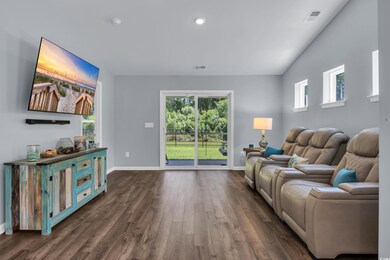 Living room featuring dark wood-style floors and recessed lighting