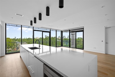 Large floor-to-ceiling windows bathe the living sp