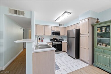 KITCHEN WITH BREAKFAST BAR AND STAINLESS SINK