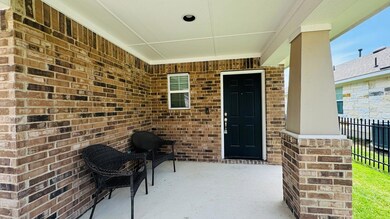 View of exterior entry featuring brick siding and