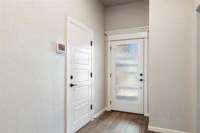 Entryway with baseboards and wood finished floors