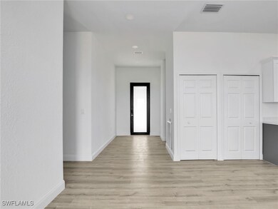 Entrance foyer featuring baseboards, visible vents
