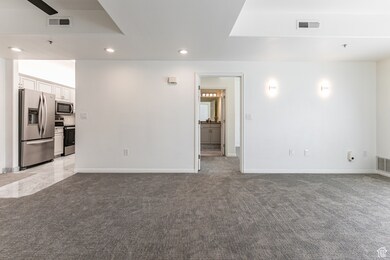 Unfurnished living room featuring recessed lighting and light carpet