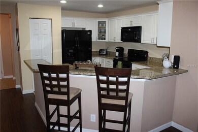 View of breakfast bar, pantry closet and front doo