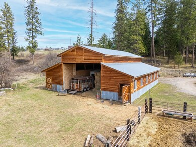 View of outdoor structure with an exterior structure, a carport, driveway, and an outbuilding