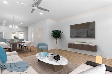 Living room with crown molding, ceiling fan with n