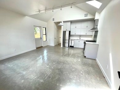 Kitchen featuring track lighting, appliances with