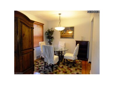 Sunny dining area with hardwood floors and newer l