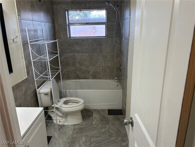 Bathroom with toilet, shower / washtub combination