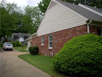 The driveway leads to a double carport with storag