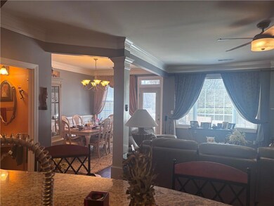 Living area with crown molding, visible vents, dec