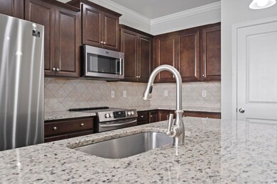 Kitchen with light stone countertops, ornamental m