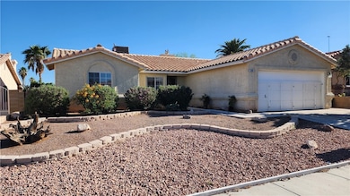 View of front of home featuring stucco siding, a g