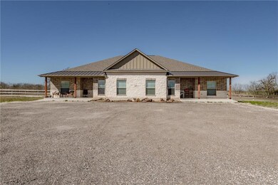 View of front facade featuring metal roof, brick s