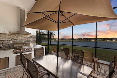 Patio terrace at dusk featuring a water view, area