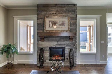 The Great Room fireplace with a rustic mantel and 