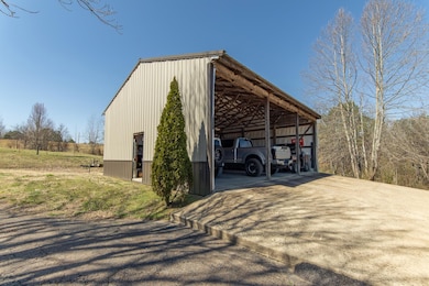 Exterior space with an outbuilding, driveway, and 