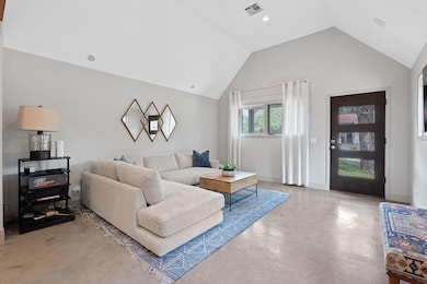 Living area with finished concrete floors and lof
