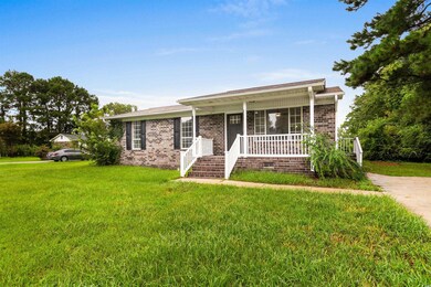 Single story home with covered porch and a front l