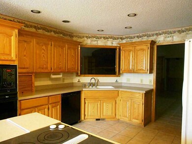 Kitchen. Hard surface, easy care counters,tile floors, tons of storage and work space.