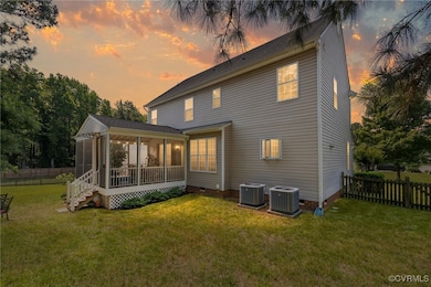 Back of house featuring a sunroom, central AC unit